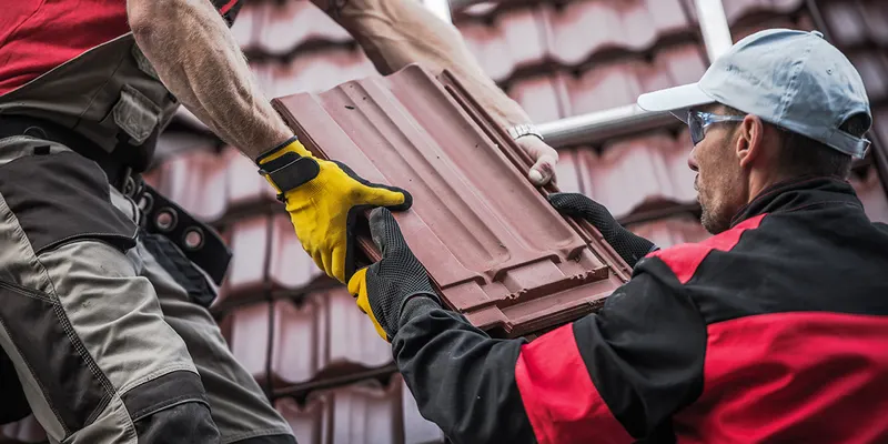 Broken roof tiles being replaced